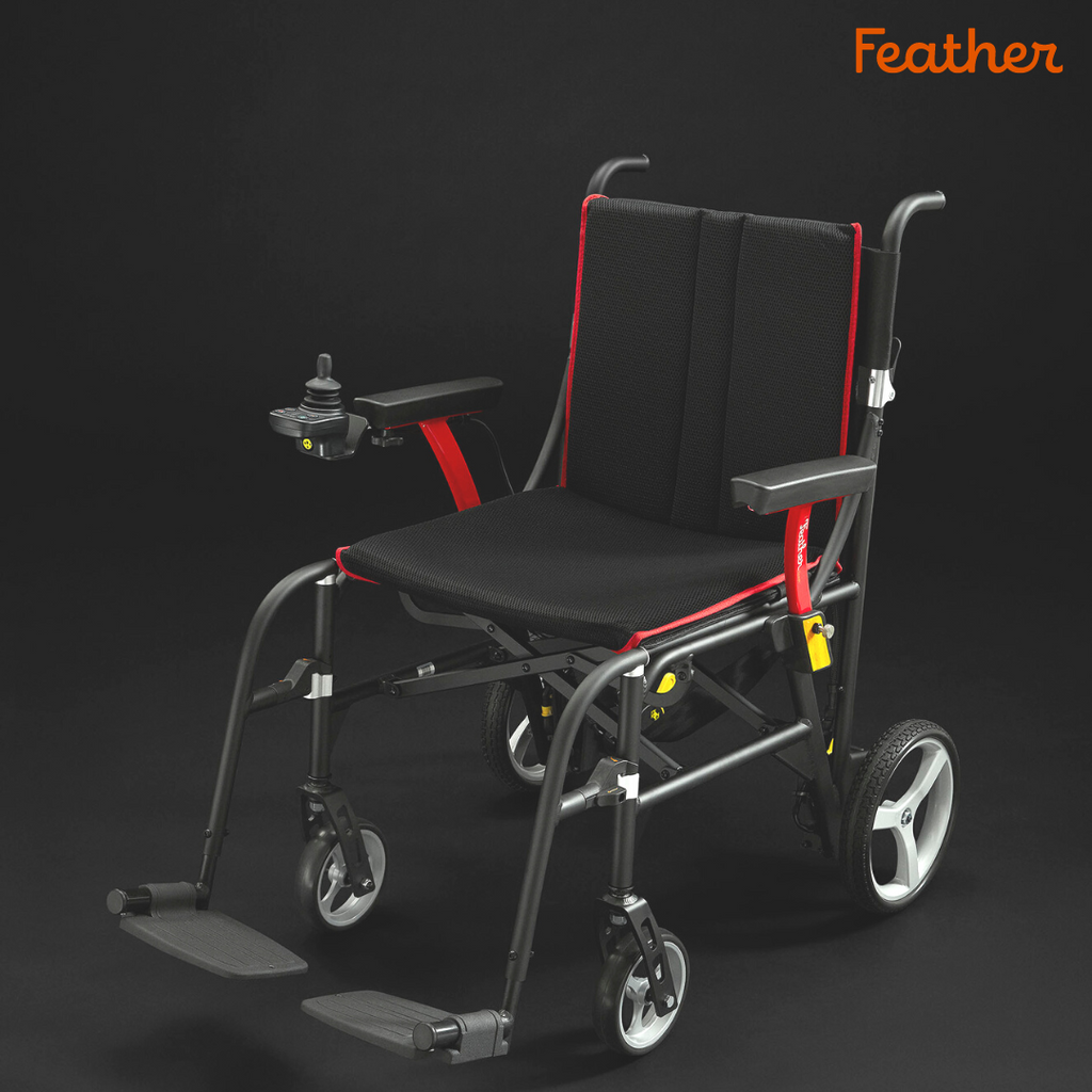 Black and red Feather Power Chair on a dark studio background